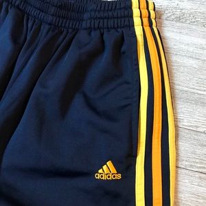 navy blue and yellow track pants